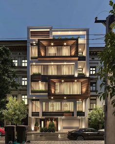 an apartment building with many windows and balconies on the second floor is lit up at night