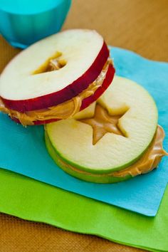 an apple and peanut butter sandwich on a blue plate