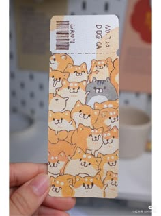 a person holding up a business card with cats on it