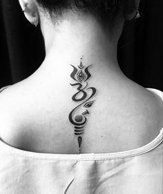 a woman's back neck tattoo with an omen symbol on her left side