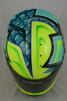 the helmet is designed to look like it has skulls on it and blue, green, black