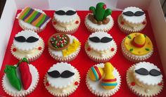 a box filled with cupcakes covered in frosting and decorated like mustaches