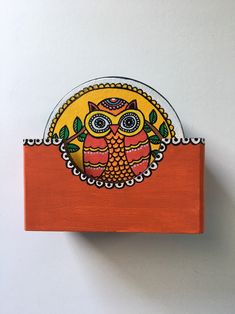 an owl painted on the side of a wooden block