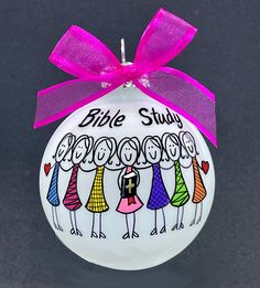 a white ornament with pink ribbon on it that says,'the bible study is