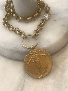 This beautiful statement necklace features an Angel medallion pendant with detailing on both and is 1.5 inches in diameter. It is antique gold plated. It hangs on a textured 8mm rolo chain in clear electroplated brass. Flower CZ connector adds a nice detail to the chain. It is offered in three length sizes: 16, 17 and 18. Choose from the menu. Lobster clasp. 🎁All orders are shipped in a box or a cloth pouch. Gift messages are attached to the box. Medallion Necklace, Rolo Chain, Gorgeous Necklaces, Star Necklace, Chain Styles, Antique Gold, Charm Necklace, Charms, Necklace Etsy