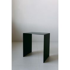 a black table sitting on top of a white floor