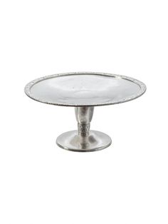 a silver cake plate sitting on top of a table