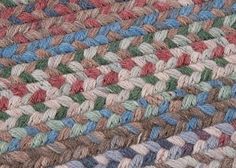 a multicolored knitted rug with different colors and patterns on the bottom half