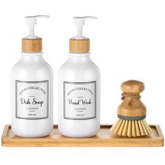 two bottles of hand soap on a wooden tray next to a scrubber and brush