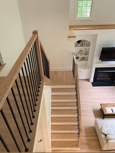 an overhead view of a living room and staircase in a house with wood flooring