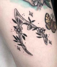 a woman's thigh with flowers and butterflies on it