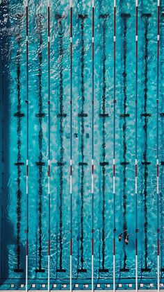 an overhead view of a swimming pool with blue water and lots of sticks sticking out of it