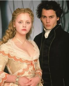 a man and woman dressed in period costumes