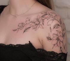 a woman's shoulder with flowers on it