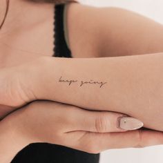 a woman's arm with the words happy friday written on it in cursive font