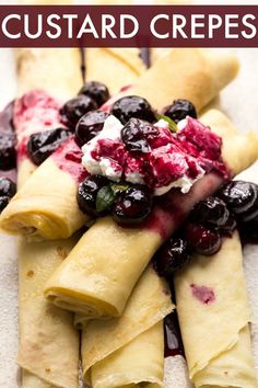 crepes with blueberries and whipped cream on them