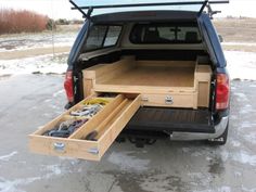 the back end of a truck with an open box in it's cargo compartment