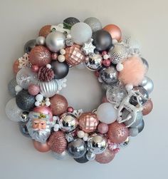 a christmas ornament wreath is hanging on the wall