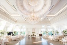 an elegant ballroom with chandeliers and tables