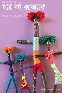 a group of sticks made to look like people with different colored yarns on them