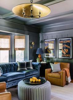 a living room with couches, chairs and pictures on the wall in it's corner