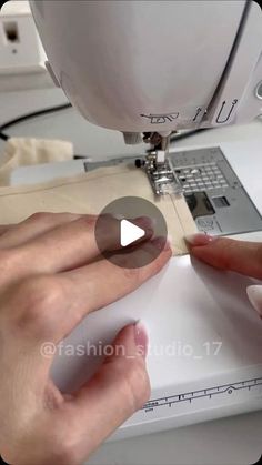 a woman is using a sewing machine to sew on her hand and the video below shows how it works