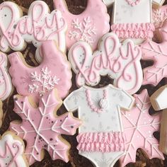 decorated cookies in the shape of snowflakes and baby ones are displayed on a table