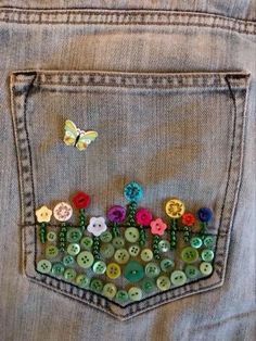 a pair of jeans with buttons in the back pocket and a butterfly on the side