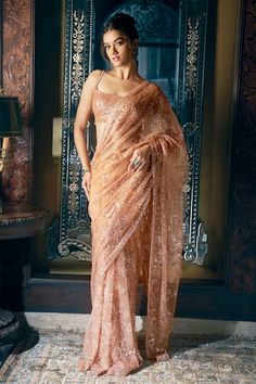 Copper saree features all over tonal sequin and crystal embroidery in a floral pattern. Comes with fully embroidered strappy, padded blouse with tassels at the waist and a petticoat. - Aza Fashions Strappy Blouse, Seema Gujral, Sequin Saree, Crystal Embroidery, Set Saree, Saree Gown, Indian Fashion Designers, U Neck, Blouse Styles