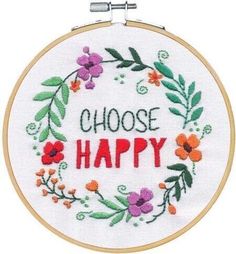 a cross - stitch hoop with the words choose happy in red, orange and purple flowers