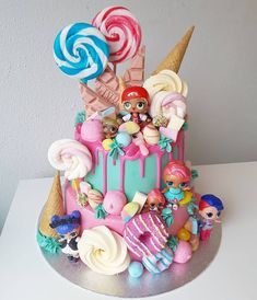 there is a cake decorated with candy and lollipops