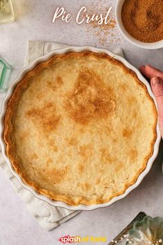 a pie crust in a white dish on top of a table