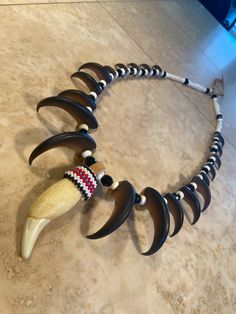 "This item is Proudly Native American Made and will come with a Certificate of Authenticity stating my enrollment and clan information. I am also a member of the Native American Arts & Craft Association. Portions of each sale go to my local community, tribe etc. This is made with a high quality resin black Bear claws and teeth. These are the best reproductions I can find. Sadly Reproductions are actually MORE expensive than my real claws and teeth. claws and teeth. This is the necklace you w Bear Claw Necklace, Antler Art, Claw Necklace, Bear Claw, Native American Crafts, Bear Claws, Tooth Necklace, Native American Beadwork, Native American Beading