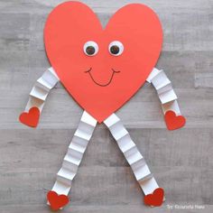 a paper heart with legs and arms made out of strips