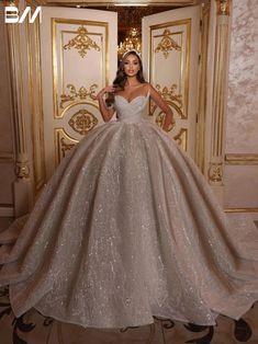 a woman standing in front of a door wearing a ball gown with sequins