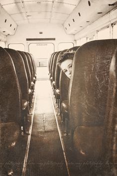 an old photo of a woman sitting on a bus