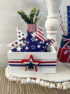 an american flag box with red, white and blue decorations in it on a table