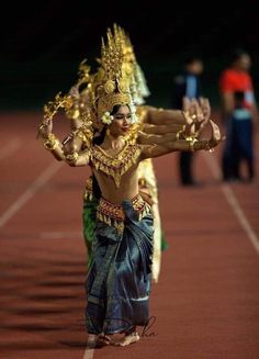 a woman in a costume is dancing on a track