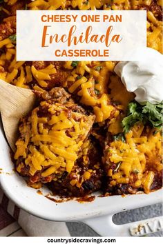 cheesy one pan enchilada casserole in a white dish