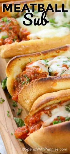 meatball subs are lined up on a cutting board