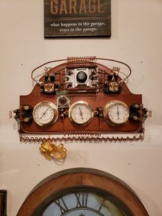 a clock mounted to the side of a wall next to a sign that says garage