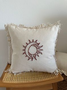 a white pillow sitting on top of a wooden chair