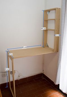 a wooden desk with blue tape on it and measurements for the top part of the table