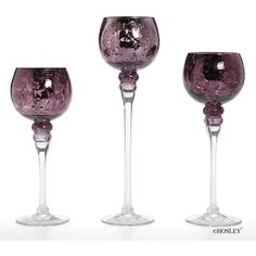 three wine goblets sitting next to each other