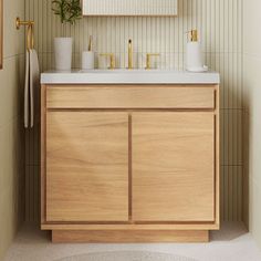 a bathroom vanity with two sinks and a mirror above it, in front of a striped wall