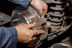 a man is working on an automobile wheel