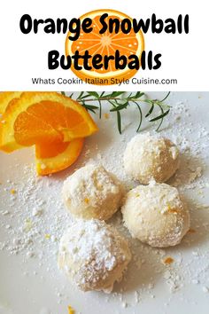 orange snowball butterballs on a white plate with an orange slice and sprig of rosemary