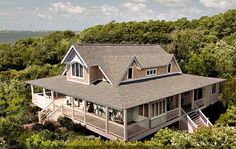 an aerial view of a house surrounded by trees