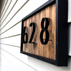 a house number sign mounted to the side of a building