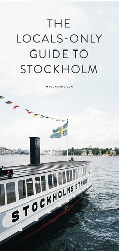 a large boat floating on top of a body of water next to a flag pole